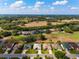 From an aerial view, one can see the community is surrounded by a golf course and lakes at 2008 Palo Alto Ave, The Villages, FL 32159