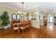 This dining room leads into the kitchen and foyer with light walls, an open layout, and hardwood flooring at 2008 Palo Alto Ave, The Villages, FL 32159