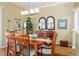 This dining room features wood floors, classic furnishings, a chandelier, and ample wall decor at 2008 Palo Alto Ave, The Villages, FL 32159