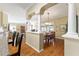 Open-concept dining room with columns and a view to the outdoor lanai and pool at 2008 Palo Alto Ave, The Villages, FL 32159