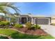 Well-maintained home showcasing a manicured lawn, mature landscaping, and a decorative driveway at 2008 Palo Alto Ave, The Villages, FL 32159