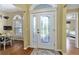 Welcoming foyer featuring decorative glass front doors and natural light at 2008 Palo Alto Ave, The Villages, FL 32159