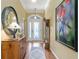 Spacious foyer with decorative front door, wooden floors, and elegant decor at 2008 Palo Alto Ave, The Villages, FL 32159