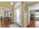 Elegant foyer with leaded glass front door, arched transom, and views into the dining room and another bedroom at 2008 Palo Alto Ave, The Villages, FL 32159