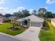 Charming single-story home featuring a well-manicured lawn and a beautifully patterned driveway at 2008 Palo Alto Ave, The Villages, FL 32159