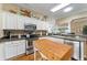 Updated kitchen with a large island, stainless appliances, and neutral countertops at 2008 Palo Alto Ave, The Villages, FL 32159