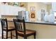 Kitchen island with seating and stainless steel appliances and white cabinetry at 2008 Palo Alto Ave, The Villages, FL 32159
