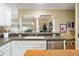 Kitchen with a view to the Gathering and dining room and stainless steel appliances at 2008 Palo Alto Ave, The Villages, FL 32159
