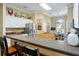 Modern kitchen featuring a breakfast bar, white cabinets, stainless steel appliances, and a bright breakfast nook at 2008 Palo Alto Ave, The Villages, FL 32159