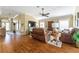 Cozy living room with ceiling fan and hardwood floors and view of the front door at 2008 Palo Alto Ave, The Villages, FL 32159