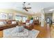 Spacious living area with leather seating, hardwood floors, and easy access to the dining area at 2008 Palo Alto Ave, The Villages, FL 32159