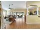 Open living room features hardwood floors, crown molding, and sliding glass doors to the pool at 2008 Palo Alto Ave, The Villages, FL 32159