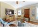 Inviting living room showcases a plush armchair, TV, and decorative cabinet at 2008 Palo Alto Ave, The Villages, FL 32159