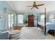 Spacious main bedroom features a ceiling fan, outdoor access and an area rug at 2008 Palo Alto Ave, The Villages, FL 32159