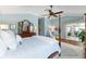 Inviting main bedroom with a four-poster bed and serene views of the screened-in patio at 2008 Palo Alto Ave, The Villages, FL 32159