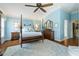 Bright and airy main bedroom featuring a four-poster bed, dresser, and light blue walls at 2008 Palo Alto Ave, The Villages, FL 32159