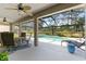 Inviting pool area with lounge chairs, stool, and views of the landscaped backyard in screened enclosure at 2008 Palo Alto Ave, The Villages, FL 32159