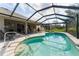 Beautiful pool with screened lanai, featuring a built-in spa, and access to an outdoor kitchen at 2008 Palo Alto Ave, The Villages, FL 32159