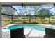 Inviting pool within screened enclosure, showcasing views of the beautifully landscaped yard and lush greenery at 2008 Palo Alto Ave, The Villages, FL 32159