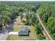 This aerial view shows a charming house surrounded by lush greenery and adjacent to convenient train tracks at 2376 Se 40Th Street Road, Ocala, FL 34480