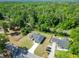 Wide aerial shot of the house, neighborhood, and lush surrounding forestry at 2376 Se 40Th Street Road, Ocala, FL 34480