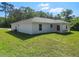 Aerial view of the home's exterior, showcasing the expansive backyard and covered patio space at 2376 Se 40Th Street Road, Ocala, FL 34480