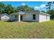 Angle shot of backyard, with a view of the home's rear exterior and an adjacent property at 2376 Se 40Th Street Road, Ocala, FL 34480