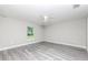 Spacious bedroom with wood-look floors, ceiling fan, and natural light at 2376 Se 40Th Street Road, Ocala, FL 34480