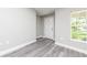 Bright entryway featuring a new white front door, gray wood-look floors, and a window allowing natural light at 2376 Se 40Th Street Road, Ocala, FL 34480
