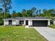 Single-story home with modern design elements, dark accents, and well-maintained landscaping at 2376 Se 40Th Street Road, Ocala, FL 34480