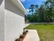 View of the side of a modern home with manicured landscaping along the walkway at 2376 Se 40Th Street Road, Ocala, FL 34480