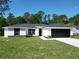 Charming single-story home featuring a modern design, black accents, fresh lawn, and a two-car garage at 2376 Se 40Th Street Road, Ocala, FL 34480