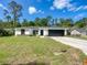 Charming front exterior view with two-car garage, well-maintained lawn, and newly installed driveway at 2376 Se 40Th Street Road, Ocala, FL 34480