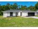 Stylish front exterior view with manicured lawn, dark accents, and freshly installed driveway at 2376 Se 40Th Street Road, Ocala, FL 34480