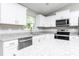 Bright, modern kitchen featuring white cabinets, granite countertops, and stainless steel appliances at 2376 Se 40Th Street Road, Ocala, FL 34480
