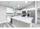 Modern kitchen featuring white cabinets, granite countertops, stainless appliances, and a large center island at 2376 Se 40Th Street Road, Ocala, FL 34480