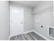 Clean laundry area features a white door, overhead shelving, and utility connections at 2376 Se 40Th Street Road, Ocala, FL 34480