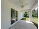 View of the covered patio featuring a ceiling fan and an expansive sliding glass door entrance at 2376 Se 40Th Street Road, Ocala, FL 34480