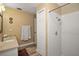 Bright bathroom features tile shower, vanity, and wood-look flooring at 26200 Se Highway 42, Umatilla, FL 32784
