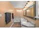 Bathroom featuring double sinks, marble countertops, modern fixtures, and framed mirrors at 26200 Se Highway 42, Umatilla, FL 32784