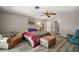 Comfortable bedroom featuring wood-look floors, a ceiling fan, and neutral paint at 26200 Se Highway 42, Umatilla, FL 32784