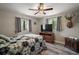 Spacious bedroom featuring wood-look flooring, ceiling fan, and windows with privacy blinds at 26200 Se Highway 42, Umatilla, FL 32784