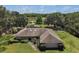 Lovely single-story home on a sprawling green lawn with mature trees and an enclosed pool in the backyard at 26200 Se Highway 42, Umatilla, FL 32784