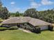 Well-maintained home featuring a stone pathway and meticulous landscaping enhancing its curb appeal at 26200 Se Highway 42, Umatilla, FL 32784