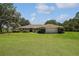 Traditional-style home on a manicured lawn, complemented by lush landscaping and an attached two-car garage at 26200 Se Highway 42, Umatilla, FL 32784