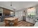 Bright kitchen with white cabinetry, stainless steel appliances, and an adjacent living space at 26200 Se Highway 42, Umatilla, FL 32784