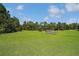 Expansive green field ready for development or recreational use, surrounded by mature trees at 26200 Se Highway 42, Umatilla, FL 32784