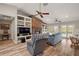 Spacious living room featuring built-in shelving, a stone fireplace, and access to the outdoors at 26200 Se Highway 42, Umatilla, FL 32784