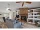 Comfortable living room with a brick fireplace, ample natural light, and cozy seating at 26200 Se Highway 42, Umatilla, FL 32784