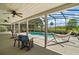Relaxing screened-in lanai overlooking a sparkling private pool and backyard at 26200 Se Highway 42, Umatilla, FL 32784